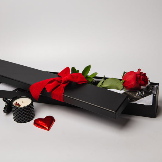 Spoil that special someone in your life with our I Love You Rose. We will select for you the perfect single premium red rose and present it in a black rose box. This gorgeous gift also comes with a scented soy 120ml Mila Mae & Co candle and finished off with a sweet chocolate red heart.