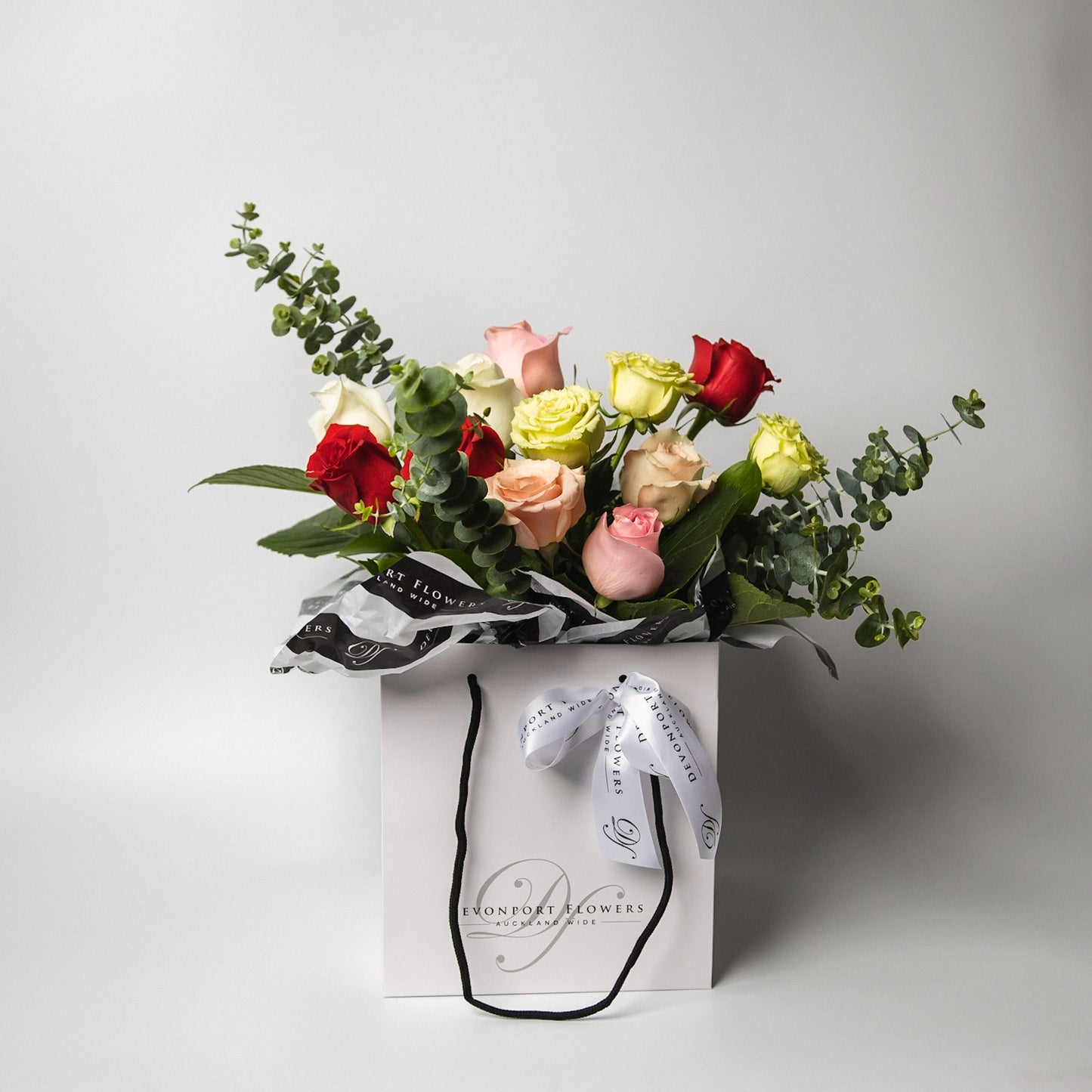 The classic and simply stunning premium mixed roses, spiralled with our lush greenery is ready to delight. Available in half and one dozen with several beautiful presentation options. 
